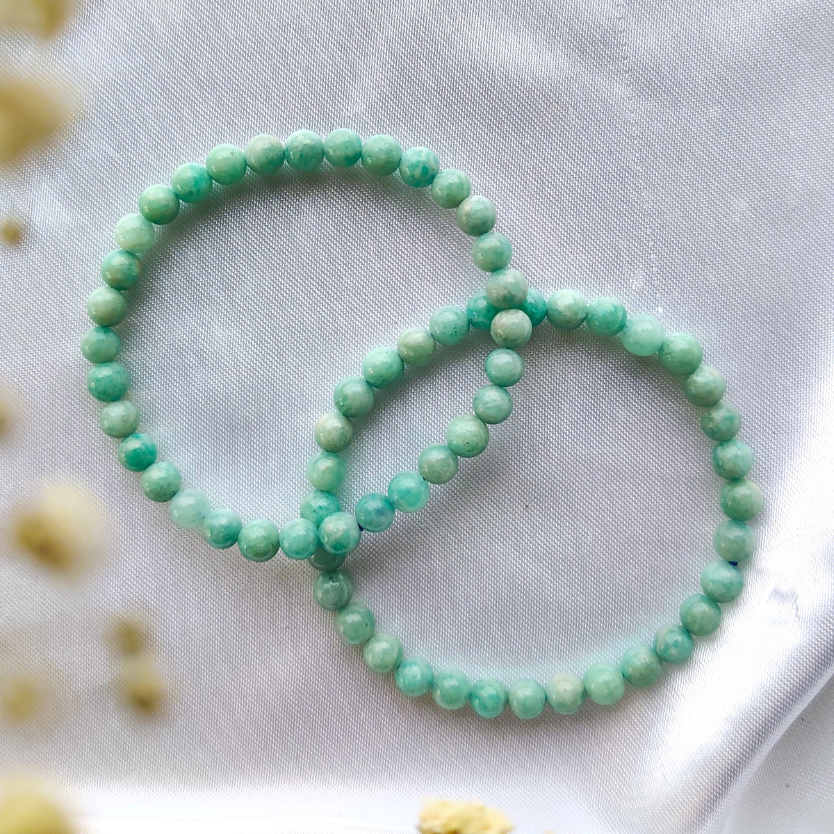 Green amazonite bead bracelet on white fabric