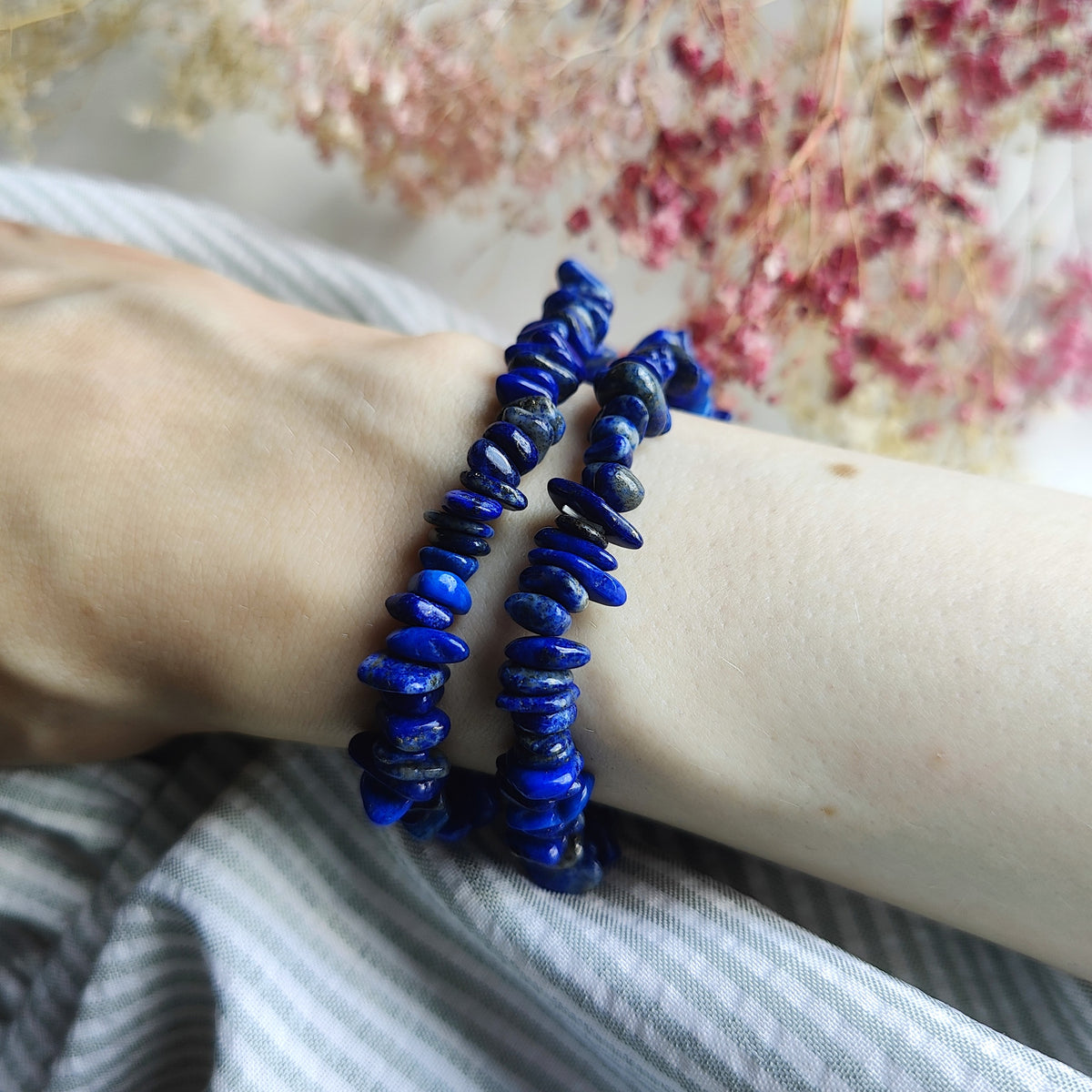 Blue lapis lazuli beaded bracelets on the wrist