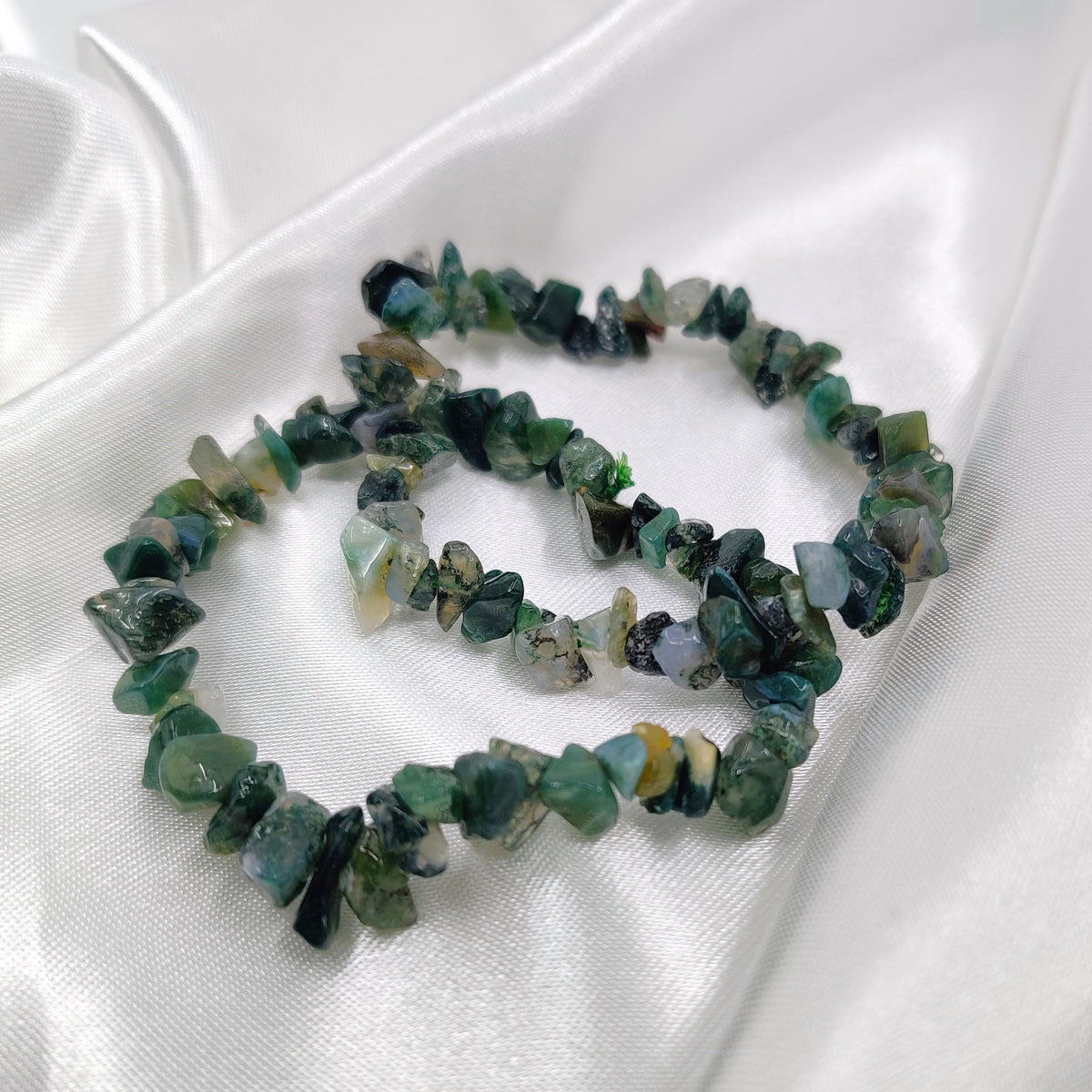 Green moss agate bead bracelet on a white background