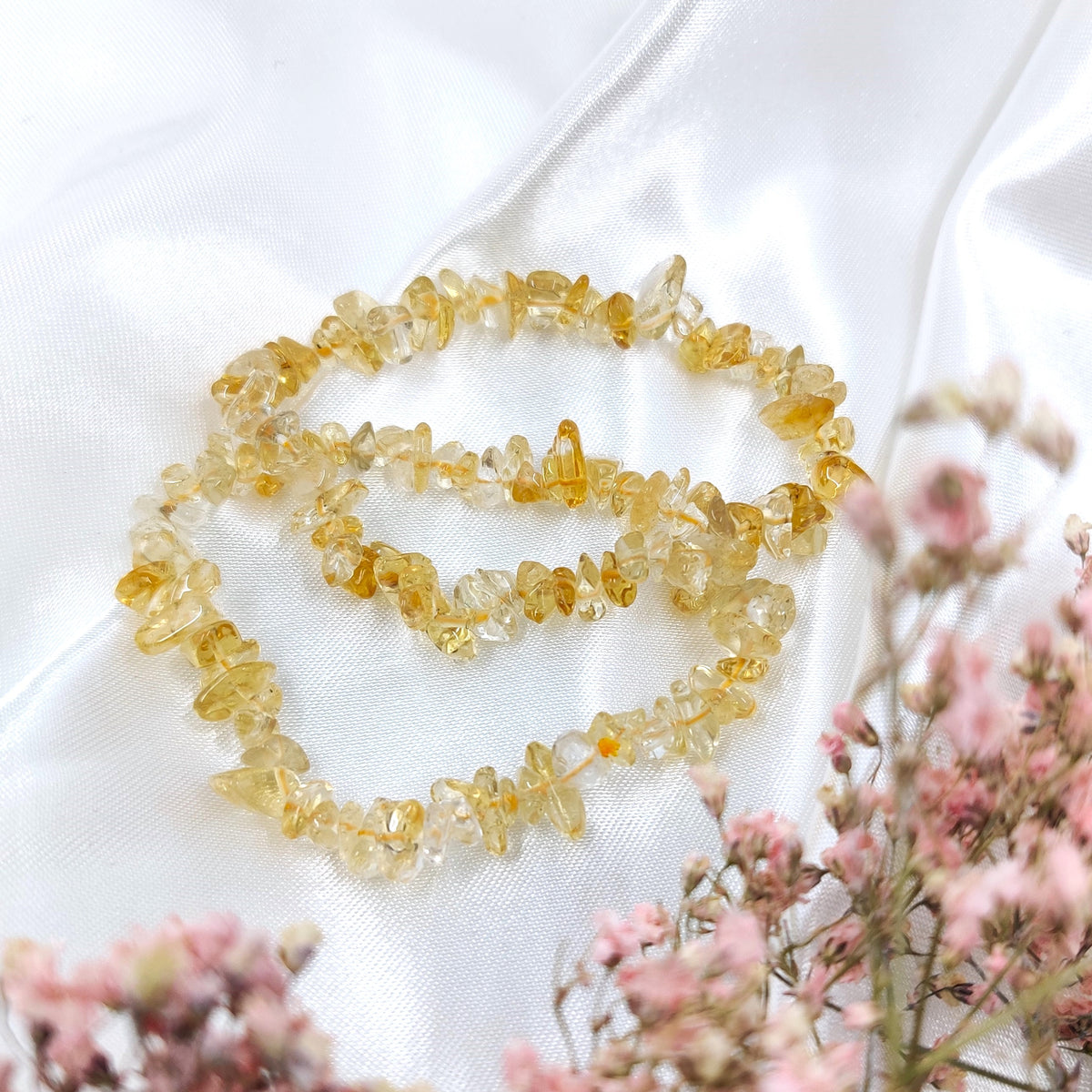 Golden translucent citrine chip bracelets on a white background